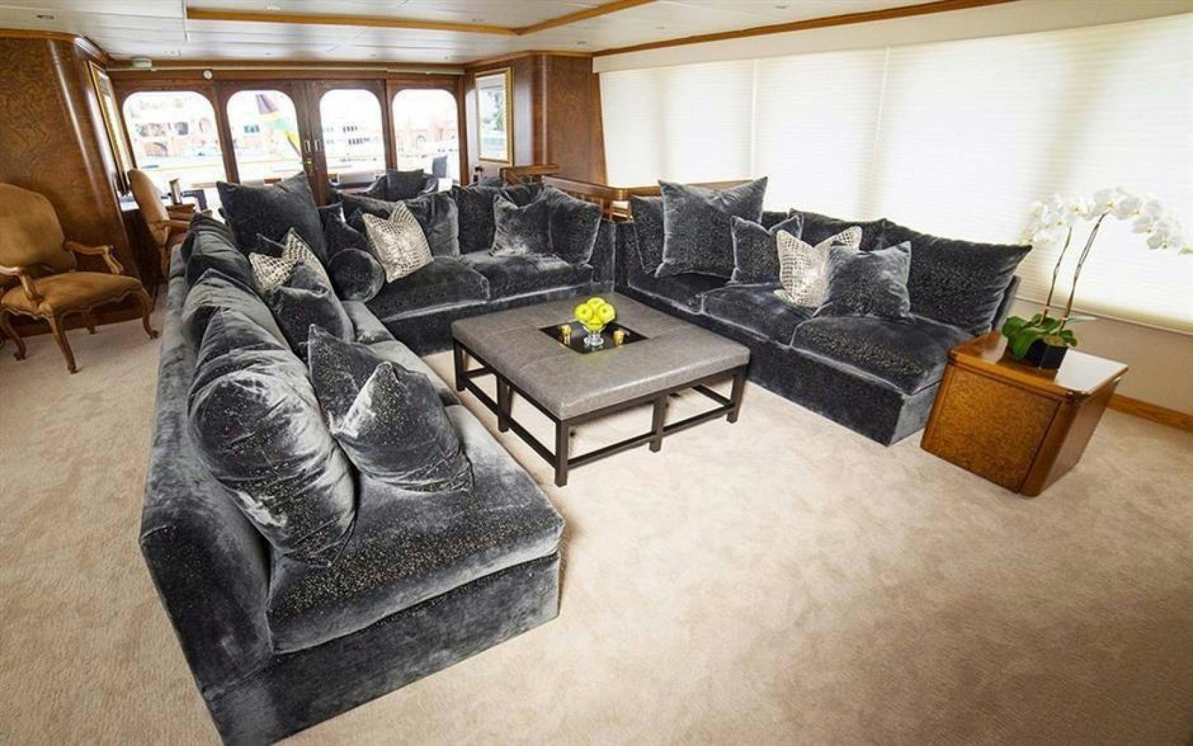 a living room with leather couches aboard GRAND ILLUSION Yacht for Sale