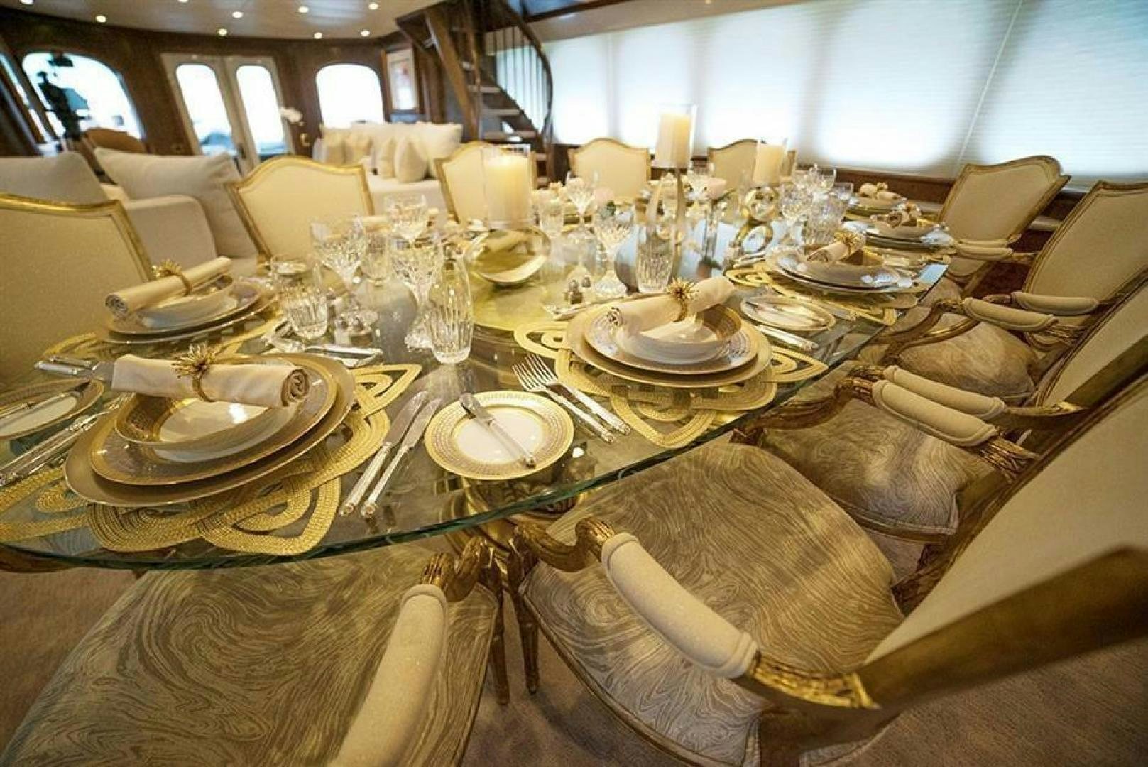 a table set with plates and glasses aboard GRAND ILLUSION Yacht for Sale