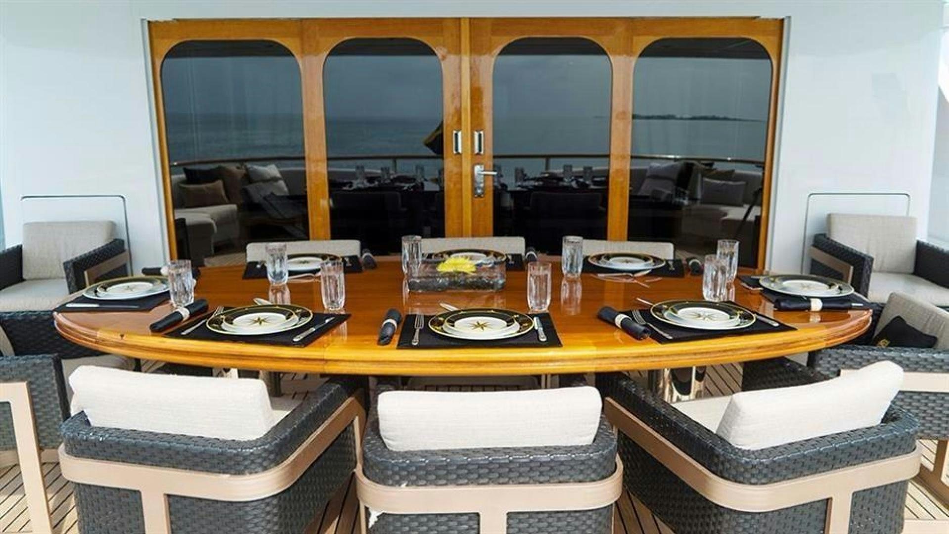 a table with plates and chairs aboard GRAND ILLUSION Yacht for Sale