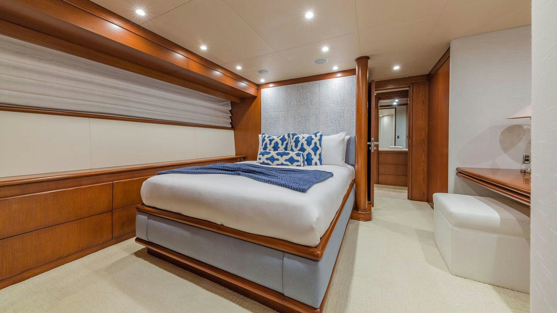 a room with a bed and a mirror aboard AT LAST Yacht for Sale
