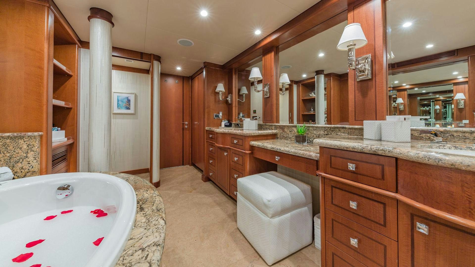 a bathroom with a tub sink and toilet aboard AT LAST Yacht for Sale