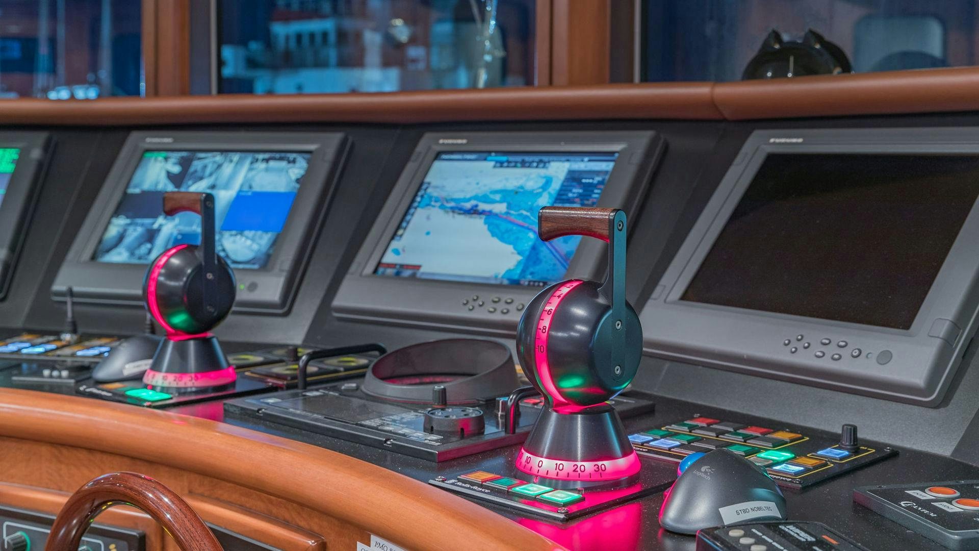 a desk with a computer and a couple of monitors aboard AT LAST Yacht for Sale