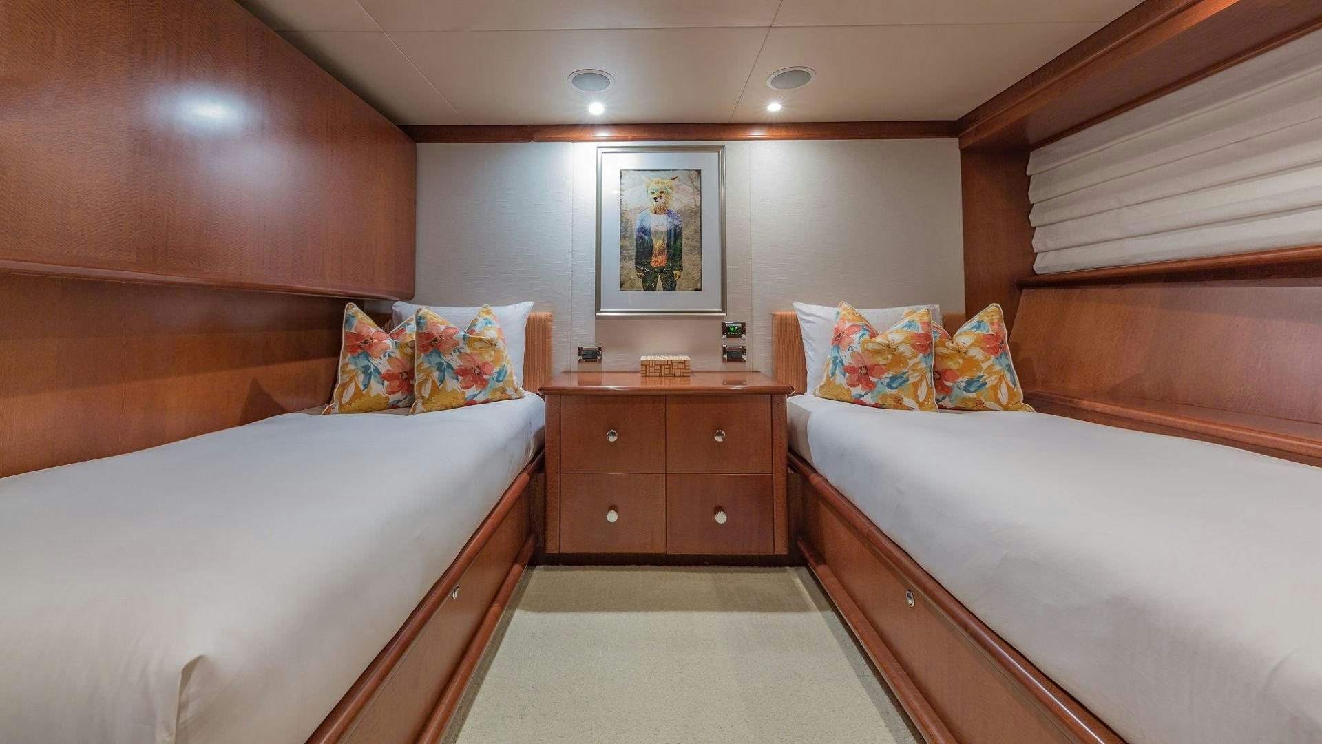 a room with a couple of beds aboard AT LAST Yacht for Sale