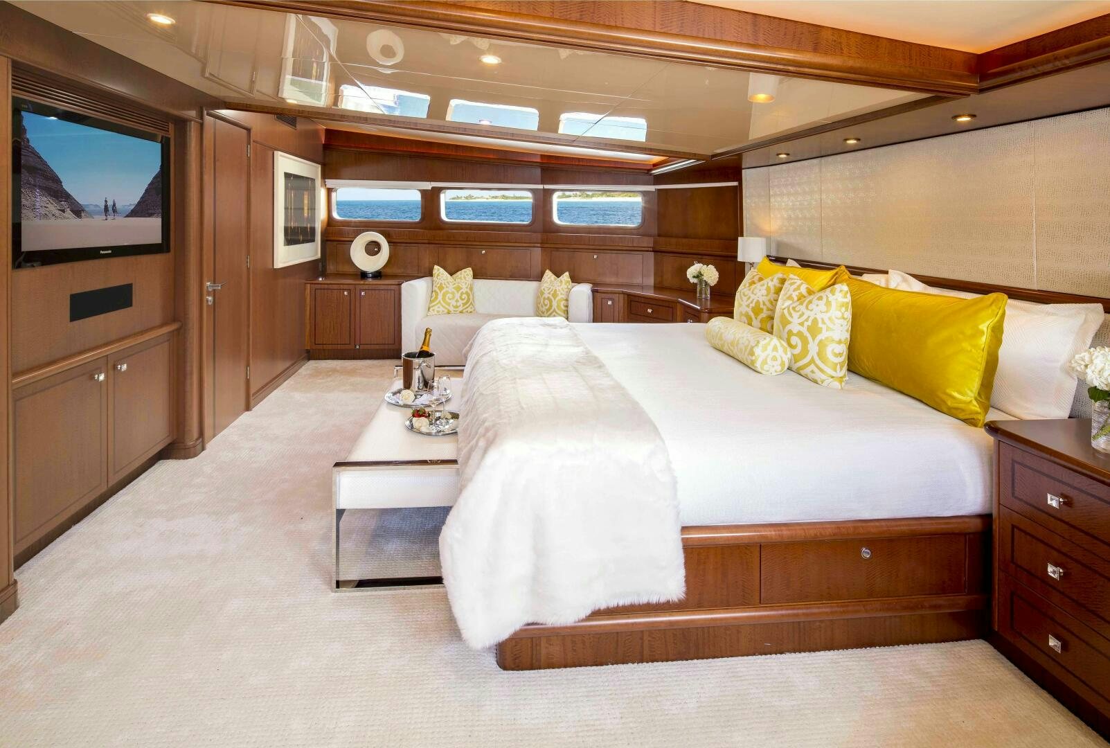 a room with a bed and a television aboard AT LAST Yacht for Sale
