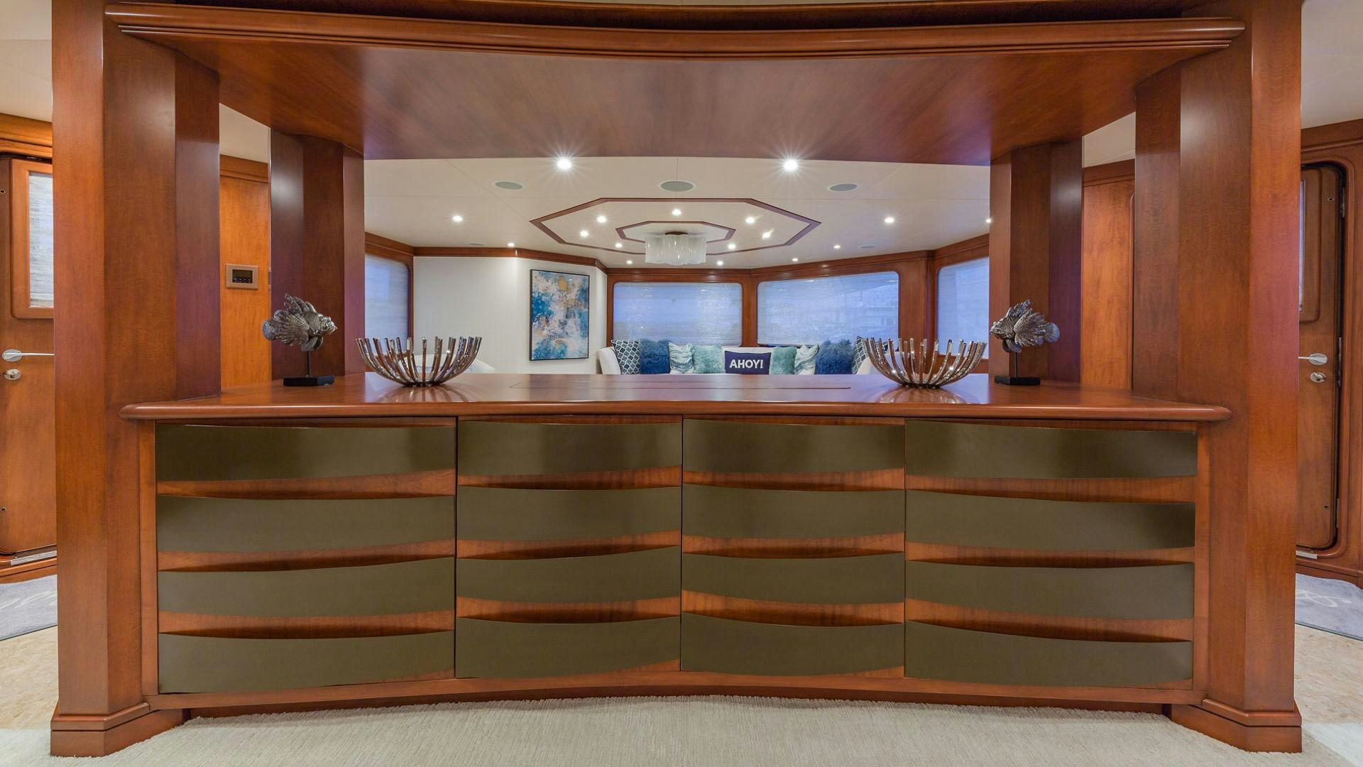 a wooden counter with a glass display aboard AT LAST Yacht for Sale