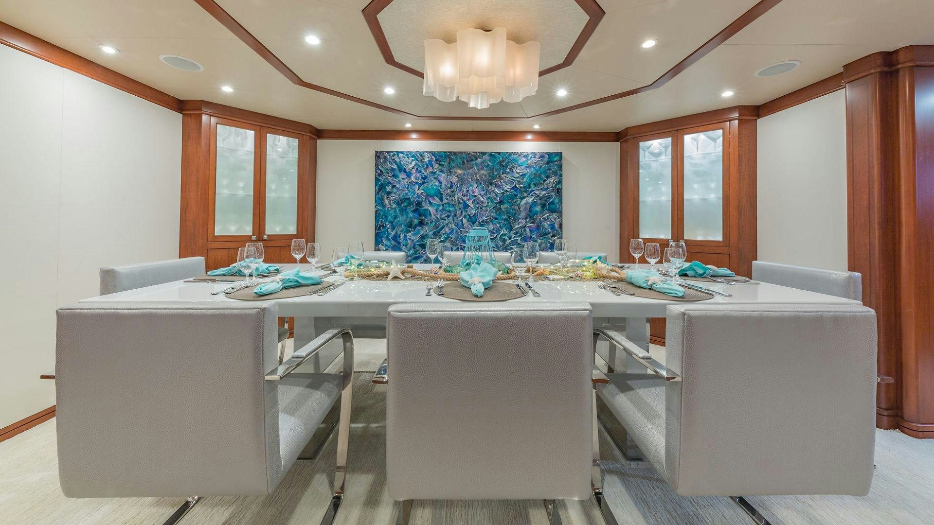 a large white office with a large table and chairs aboard AT LAST Yacht for Sale