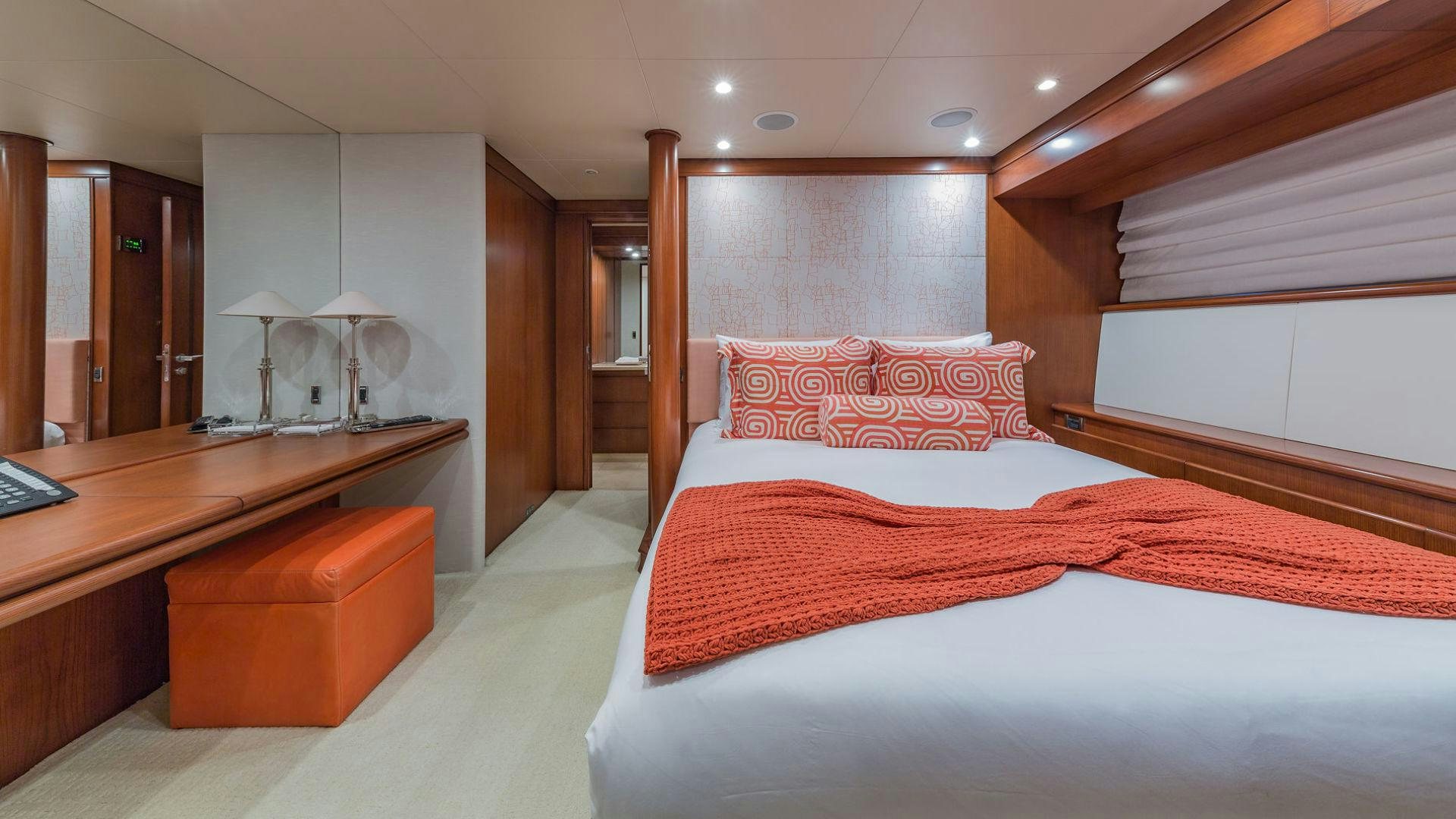 a room with a bed and desk aboard AT LAST Yacht for Sale