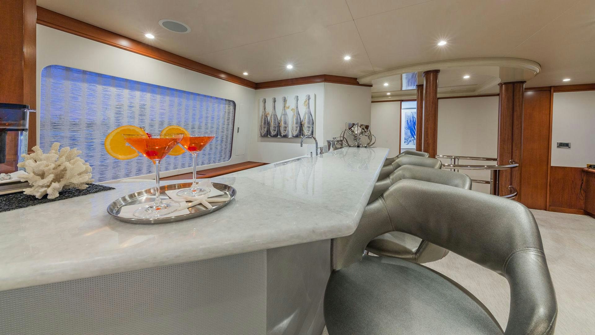 a living room with a large table and chairs aboard AT LAST Yacht for Sale