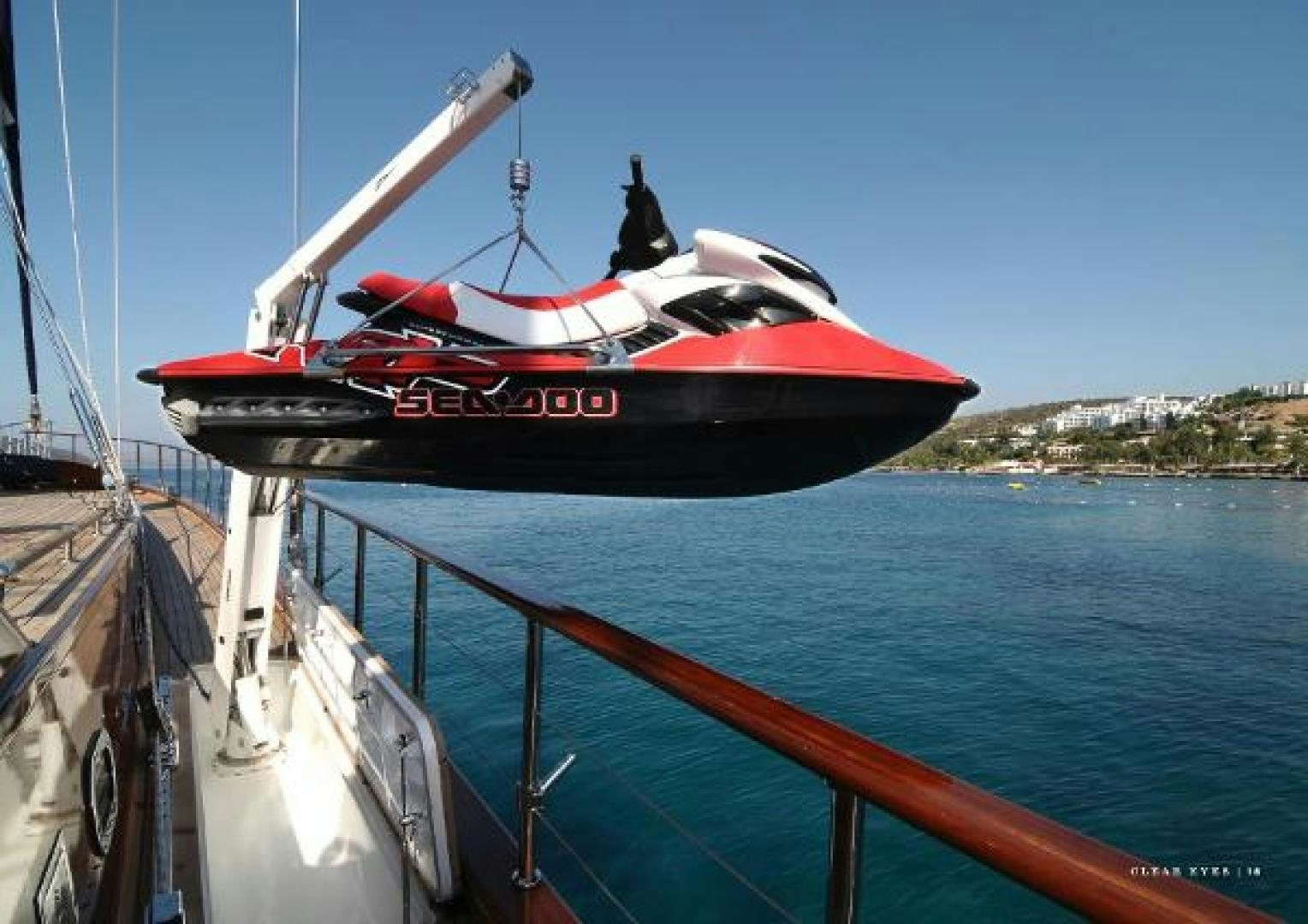 a red and black boat on a body of water aboard CLEAR EYES Yacht for Sale