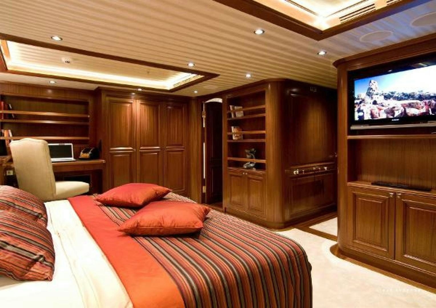 a bedroom with a tv and a bed aboard CLEAR EYES Yacht for Sale