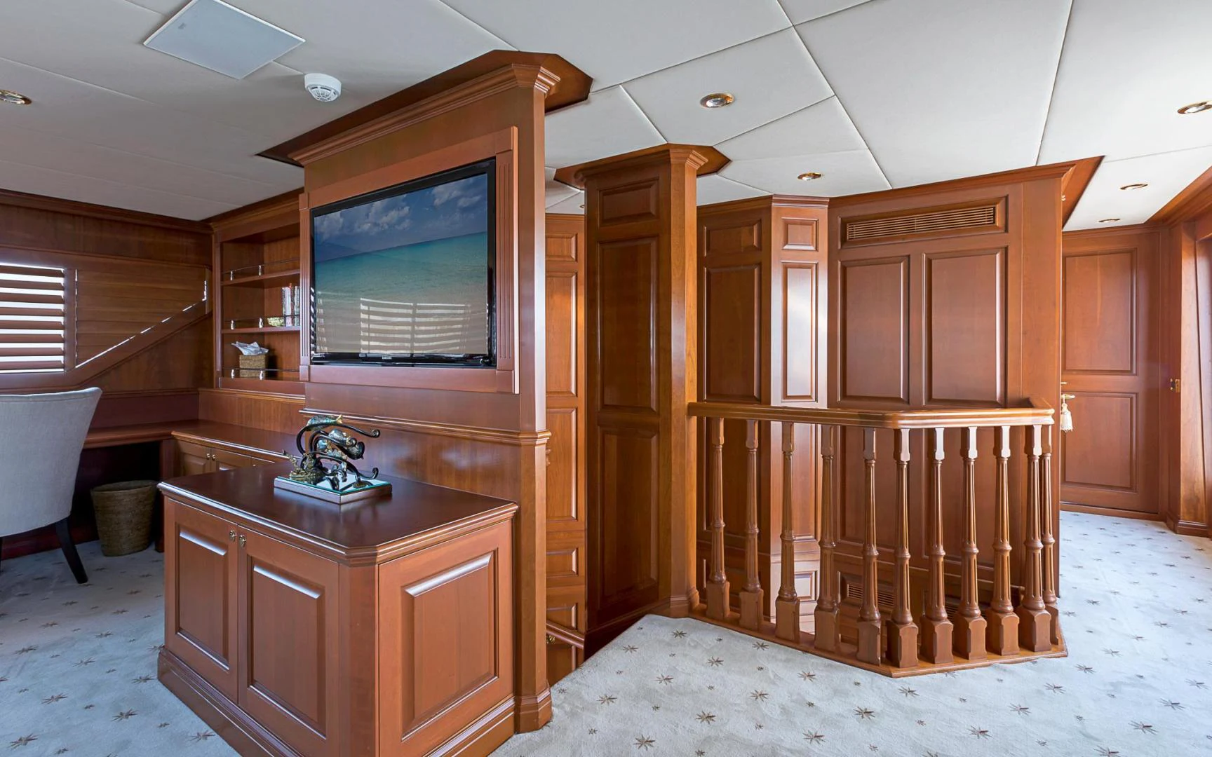 a bathroom with a wood cabinet and a television aboard TRUE NORTH Yacht for Sale