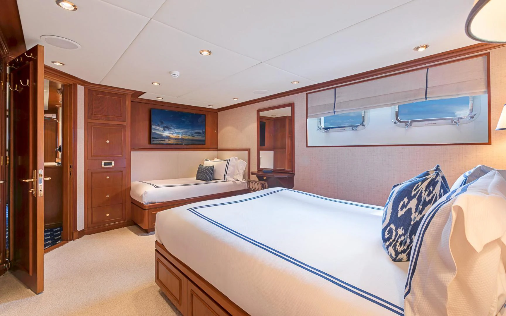 a room with a bed and a television aboard TRUE NORTH Yacht for Sale