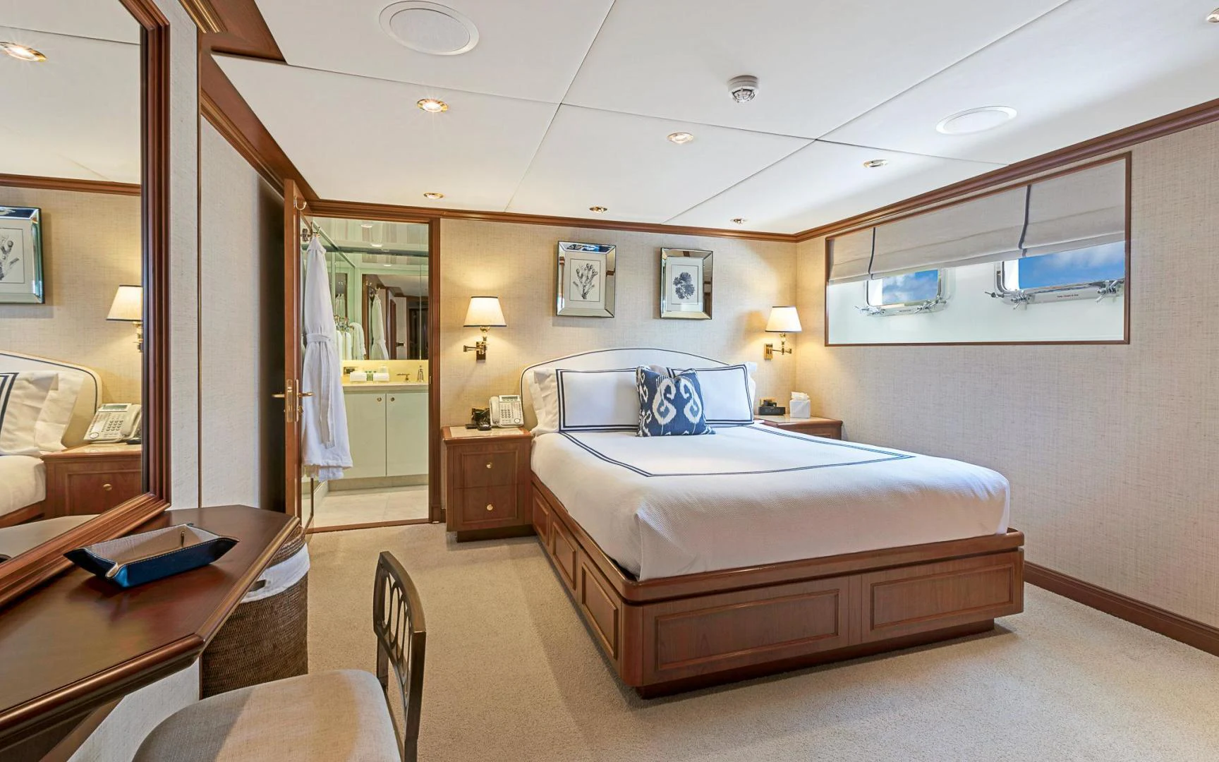 a bedroom with a bed and a desk aboard TRUE NORTH Yacht for Sale