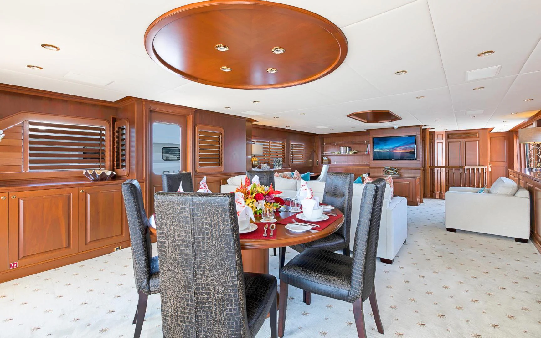 a living room with a table and chairs aboard TRUE NORTH Yacht for Sale