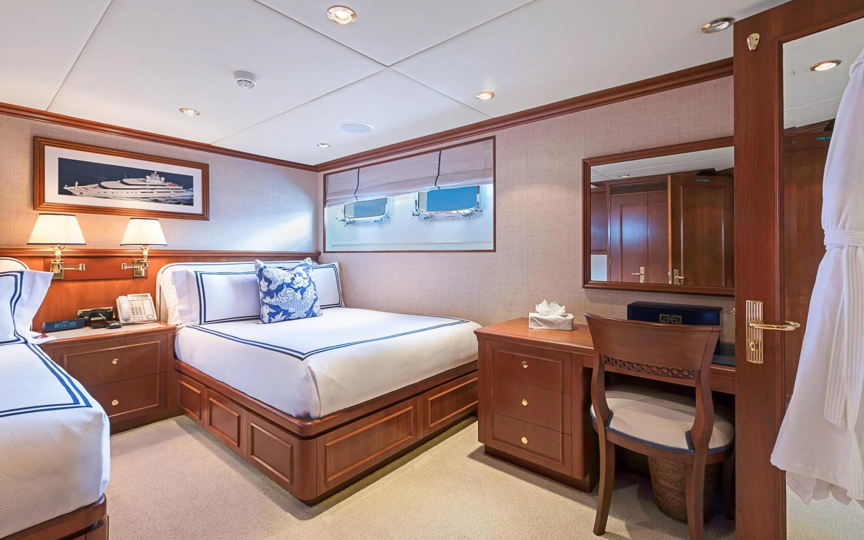 a bedroom with a bed and a desk aboard TRUE NORTH Yacht for Sale