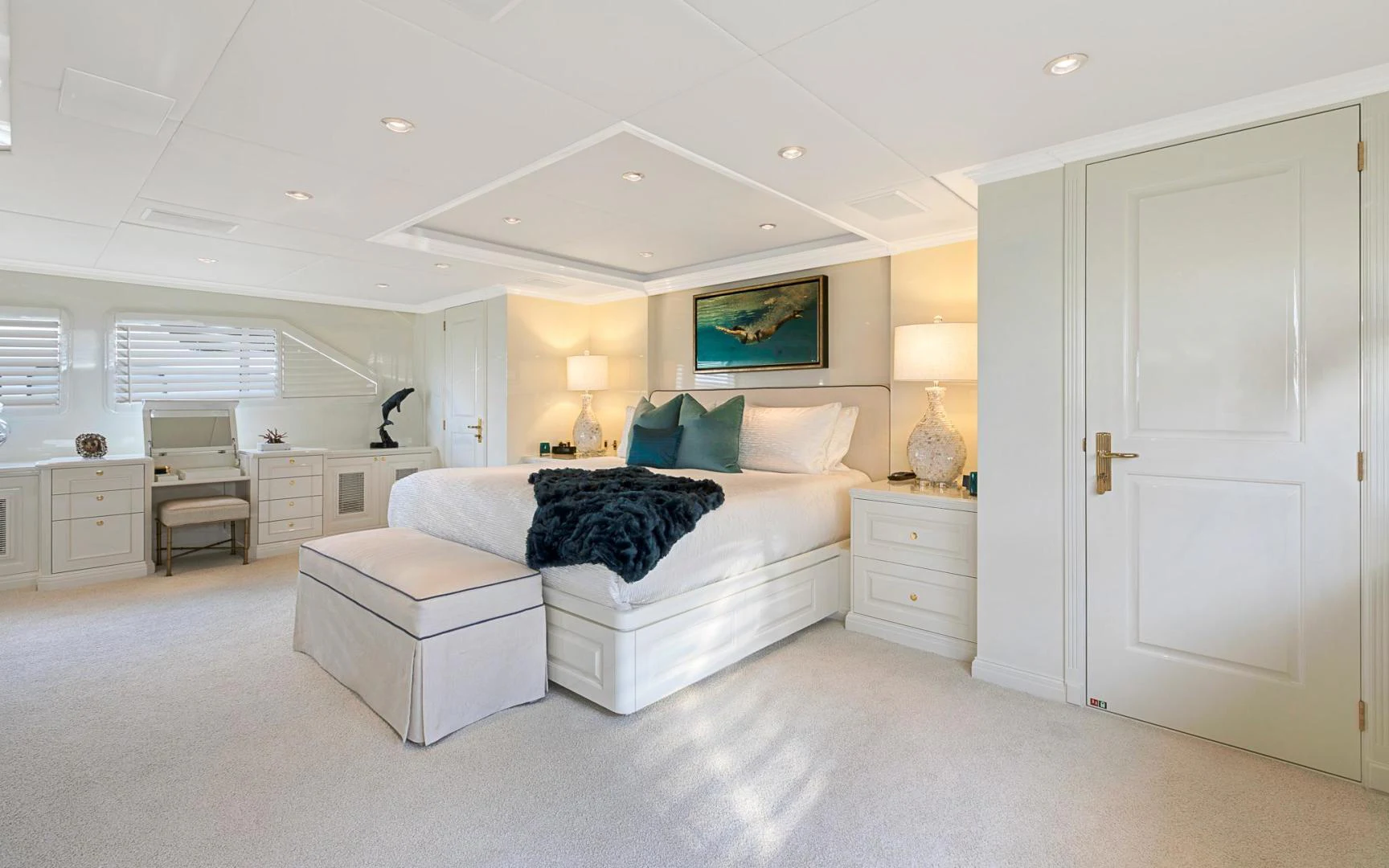 a large white bedroom with a large bed and a large white door aboard TRUE NORTH Yacht for Sale