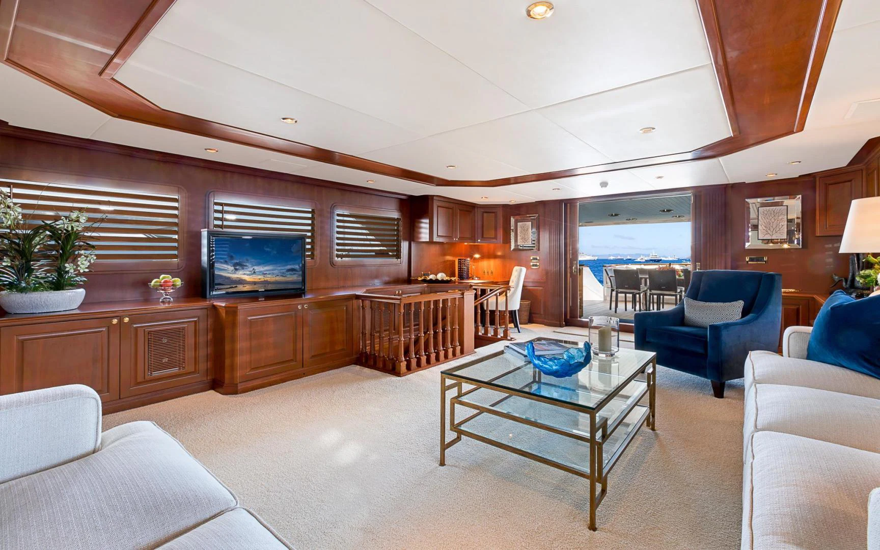 a living room with a large wood table and chairs aboard TRUE NORTH Yacht for Sale