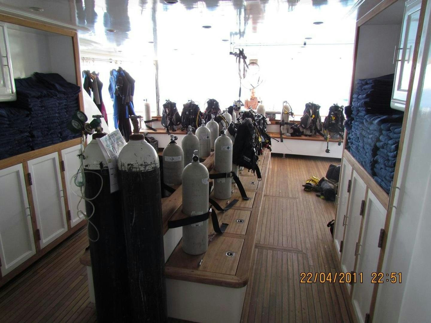a room with many bottles on the floor and people standing in the background aboard NO NAME Yacht for Sale