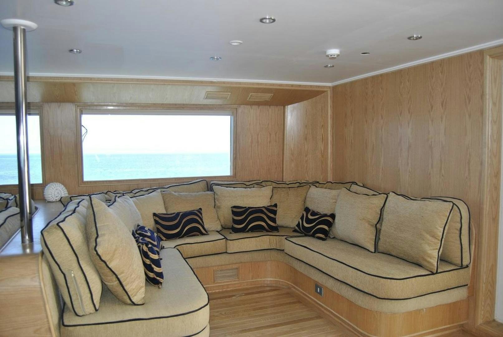 a living room with a couch and a window aboard NO NAME Yacht for Sale