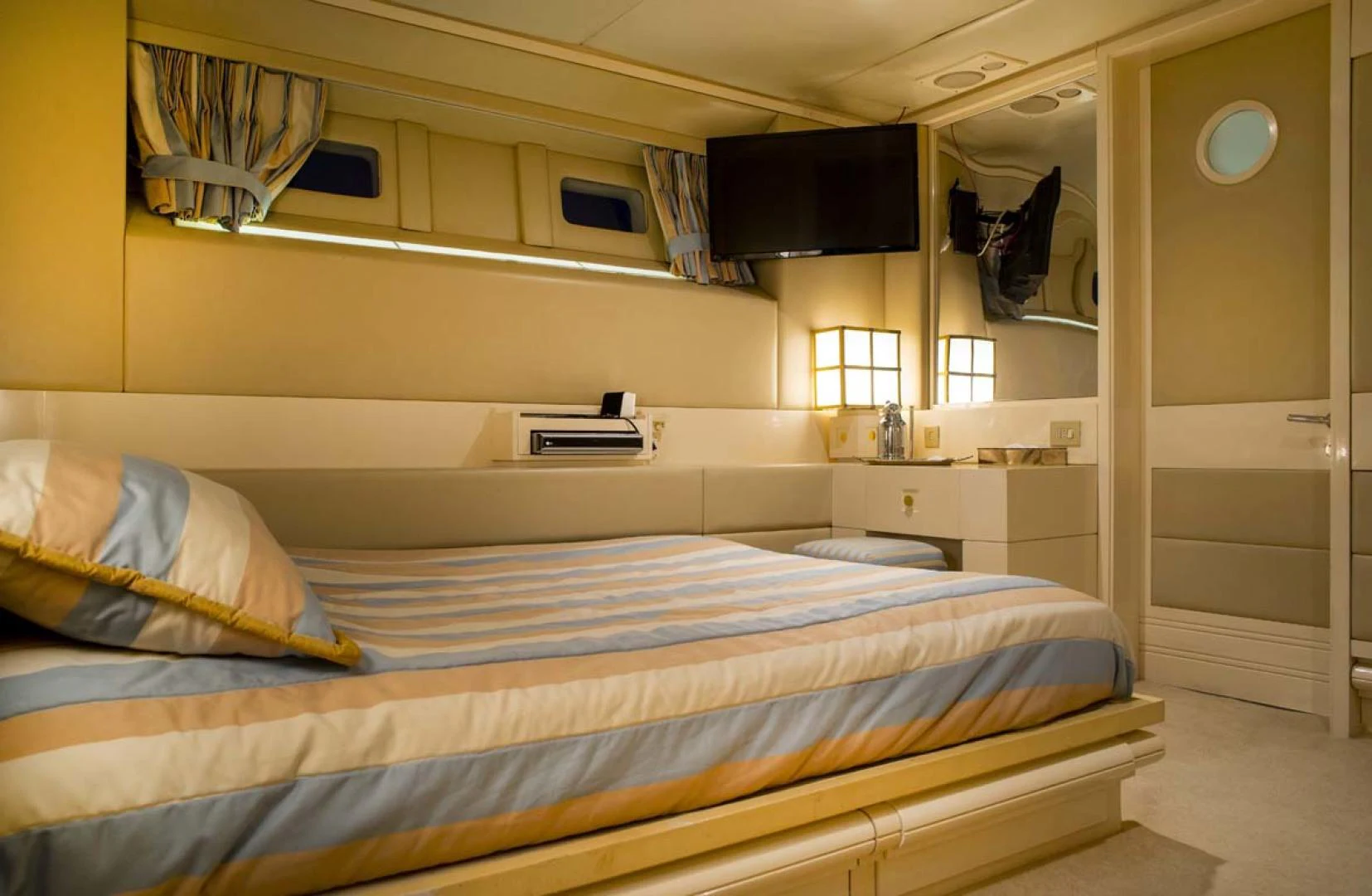 a room with a bed and a television aboard GELLY Yacht for Sale