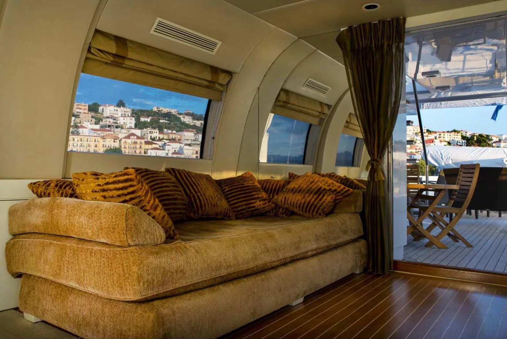 a couch with a window overlooking a city aboard GELLY Yacht for Sale
