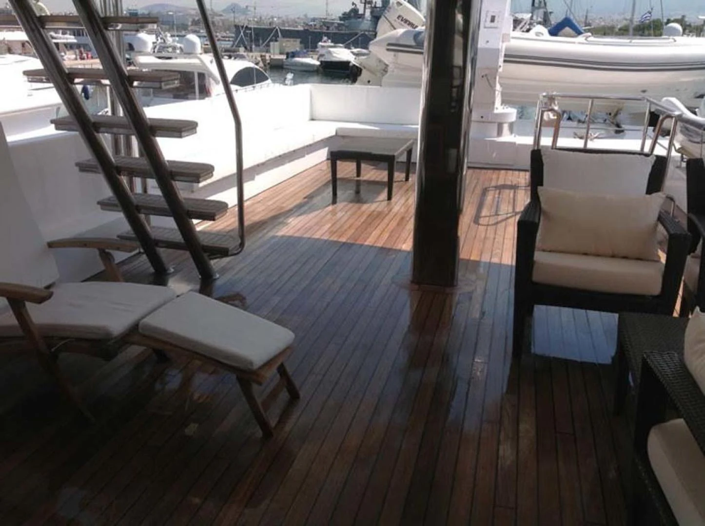 a deck with chairs and tables aboard GELLY Yacht for Sale
