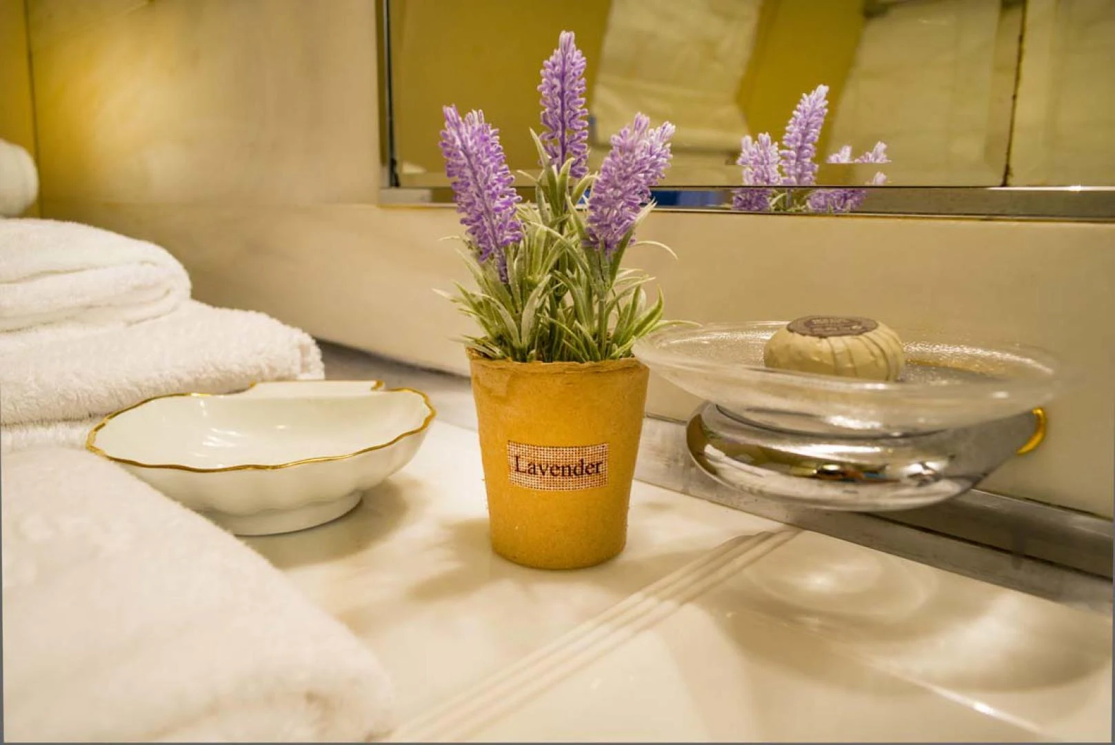 a flower pot next to a bowl of flowers aboard GELLY Yacht for Sale
