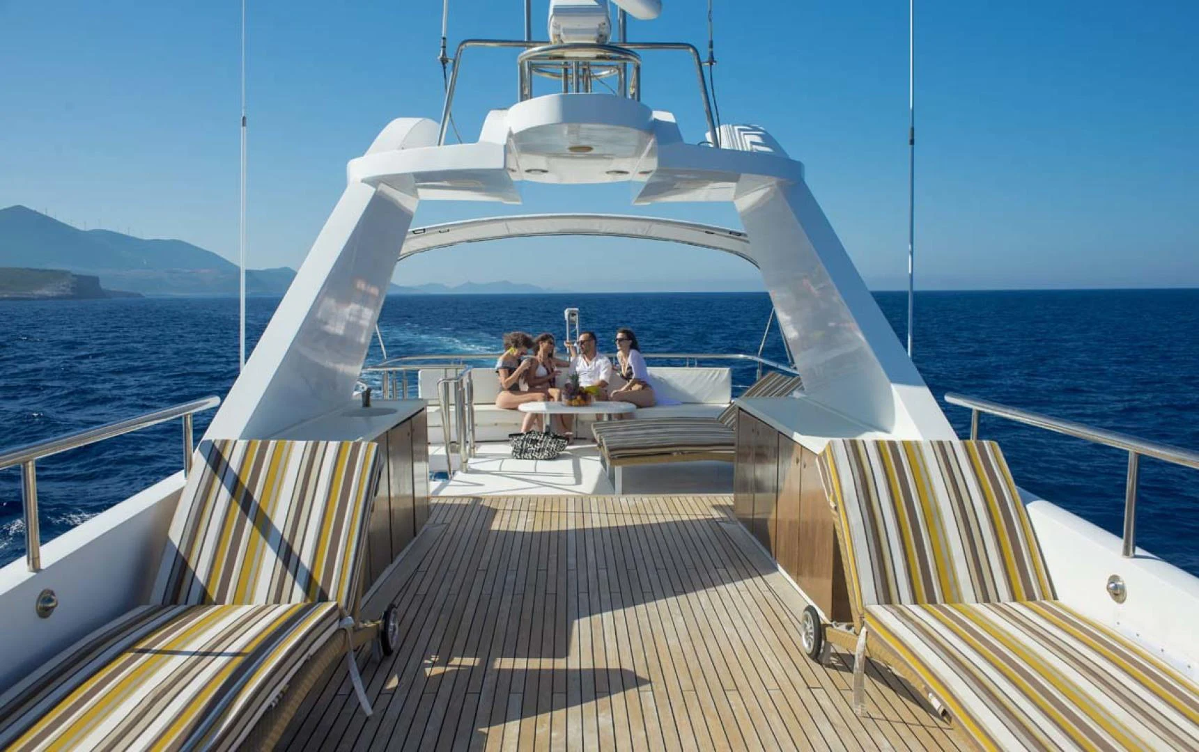 a group of people sitting on a boat aboard GELLY Yacht for Sale