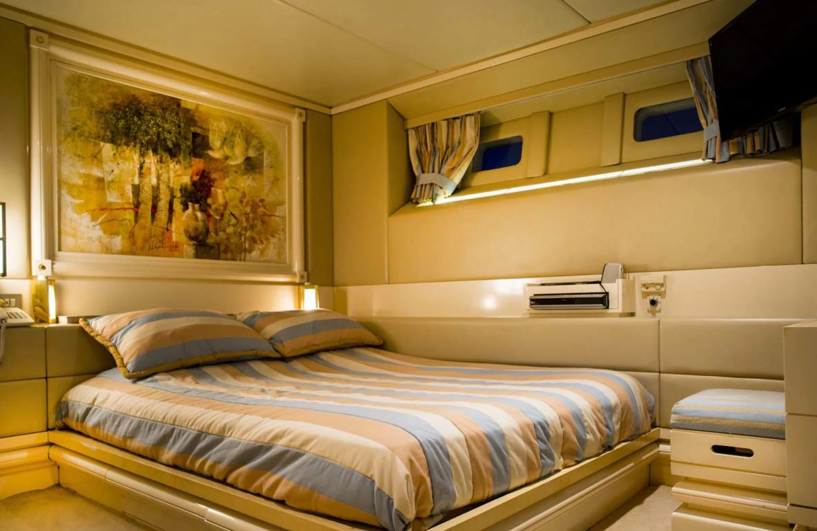 a room with a bed and a painting on the wall aboard GELLY Yacht for Sale