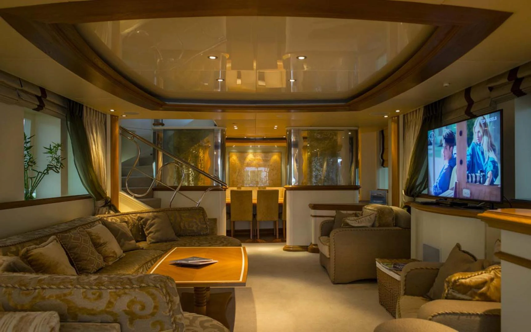 a living room with a large screen aboard GELLY Yacht for Sale
