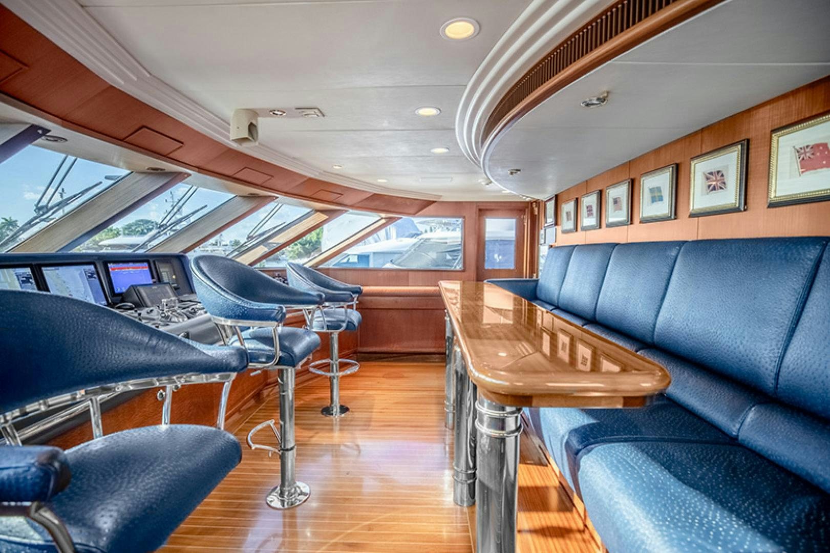 a room with a couch and a table and chairs aboard NEVER ENOUGH Yacht for Charter