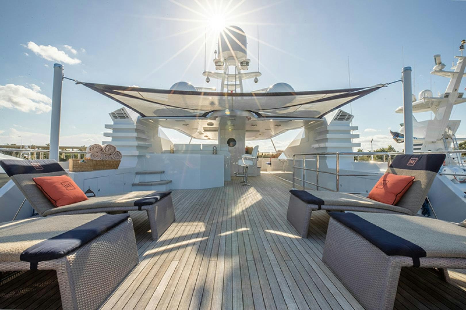a deck with a deck and a large airplane on it aboard NEVER ENOUGH Yacht for Charter