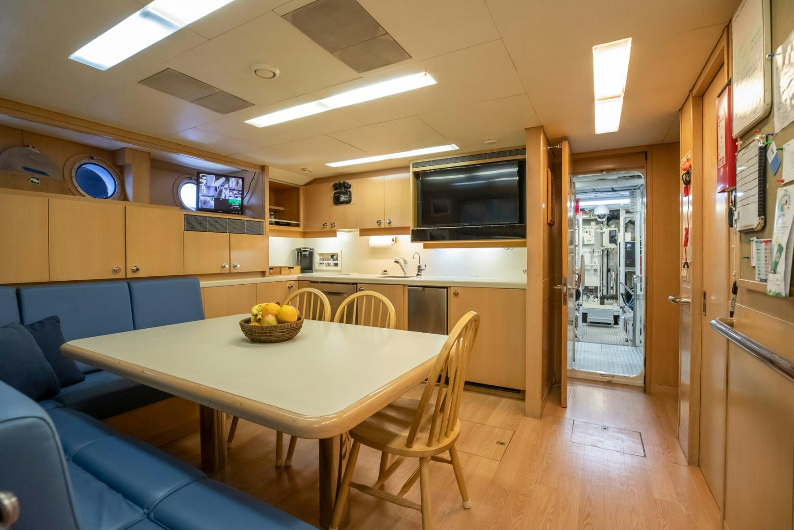 a kitchen with a table and chairs aboard NEVER ENOUGH Yacht for Charter