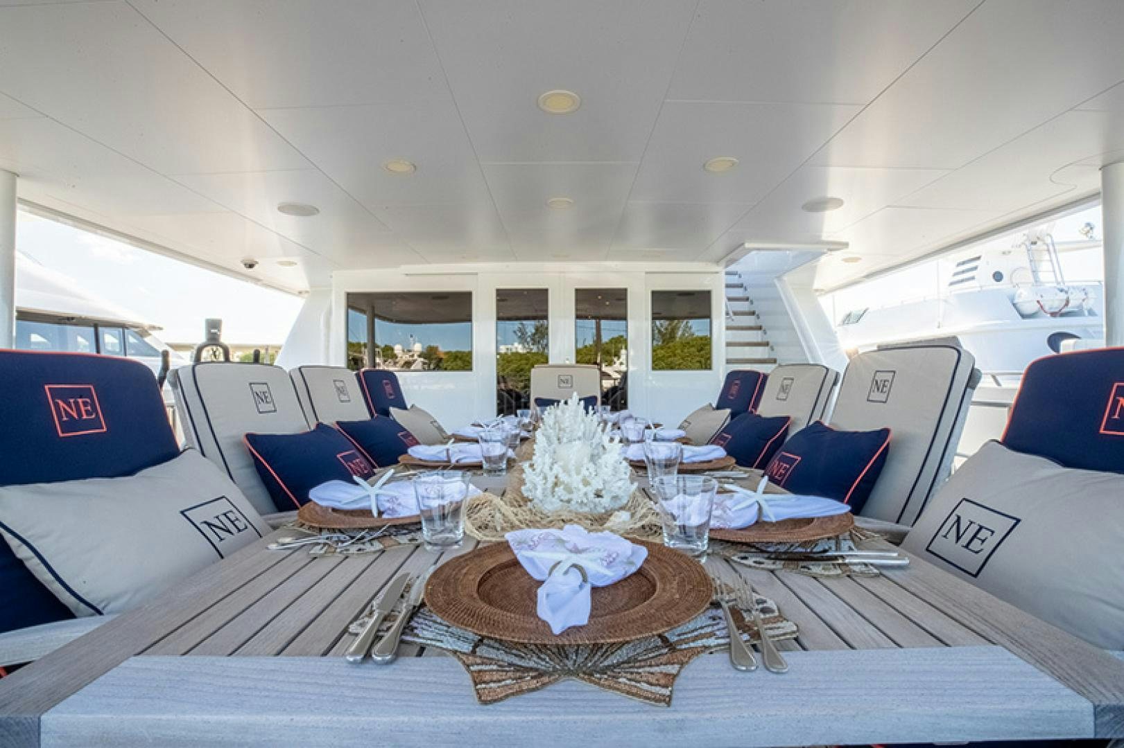a large room with a table and chairs aboard NEVER ENOUGH Yacht for Charter
