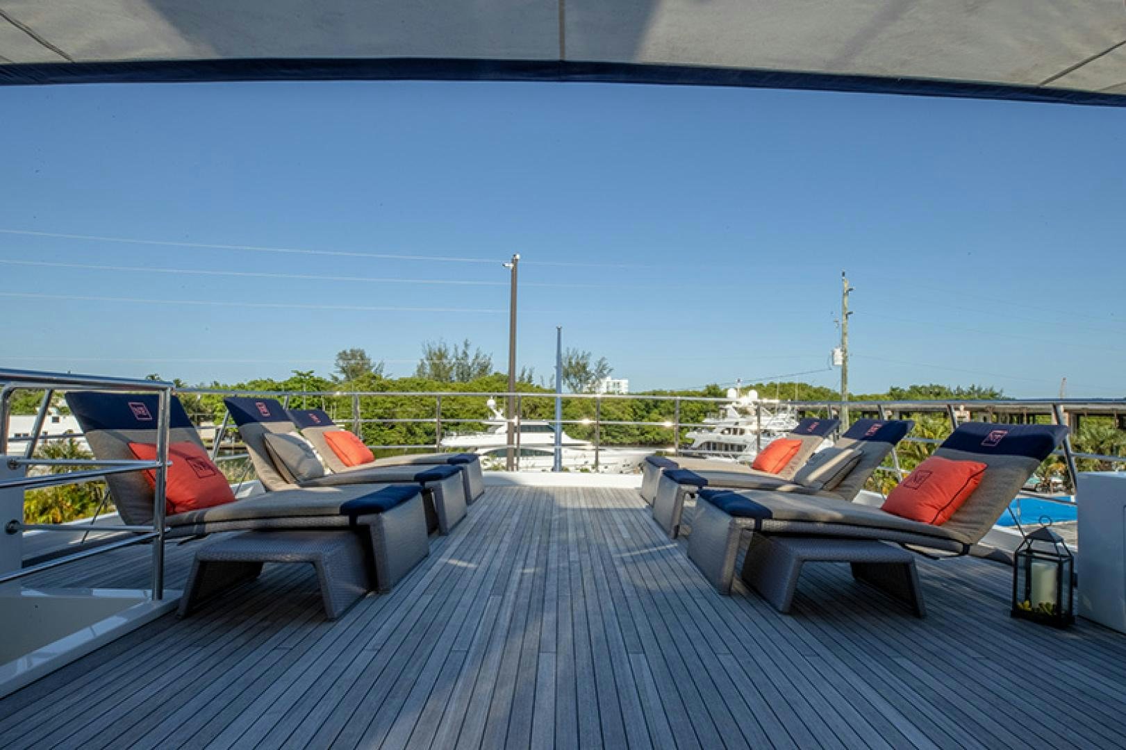 a deck with a pool and a deck with chairs and a pool aboard NEVER ENOUGH Yacht for Charter