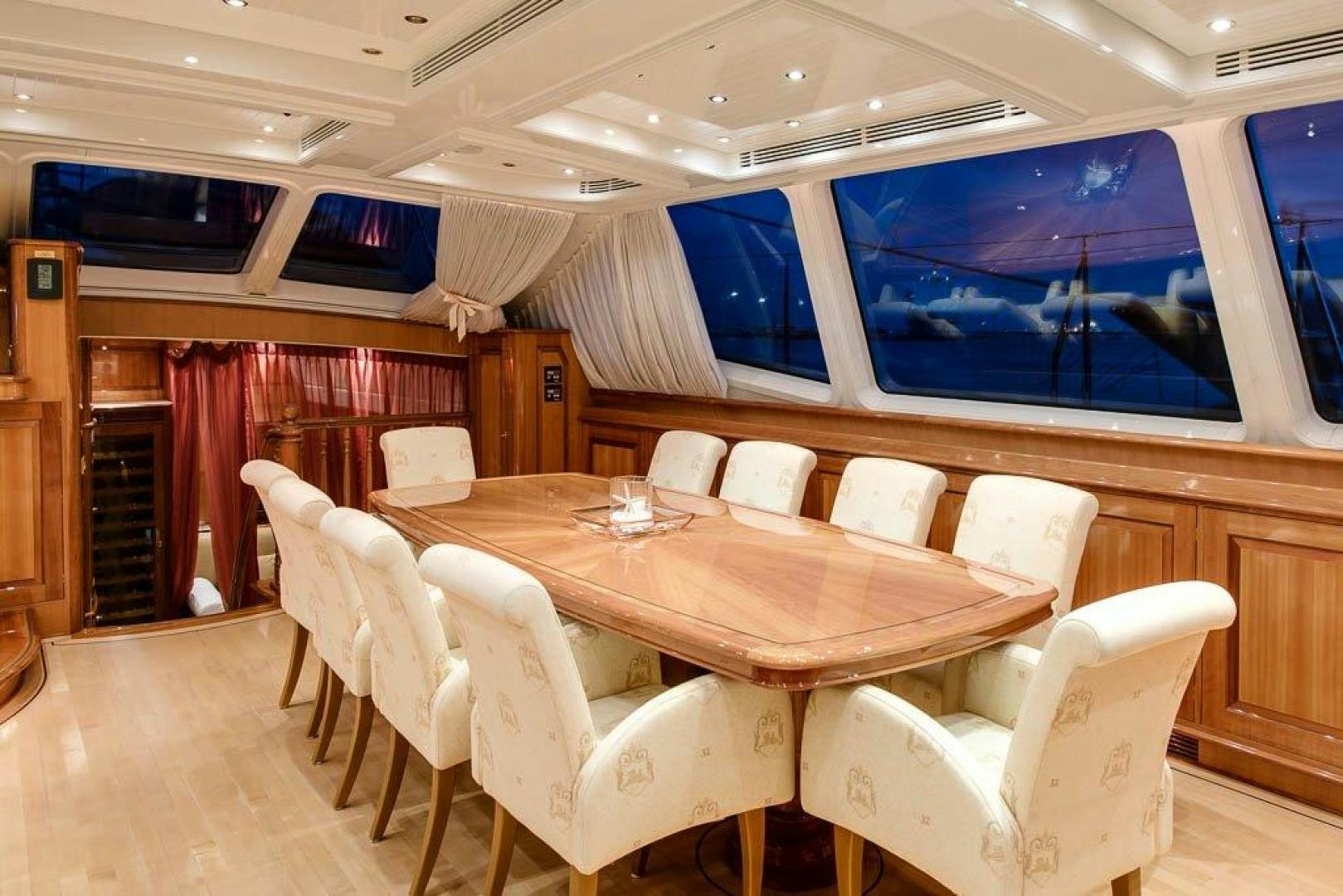 a conference room with a table and chairs aboard DELUSHA Yacht for Sale