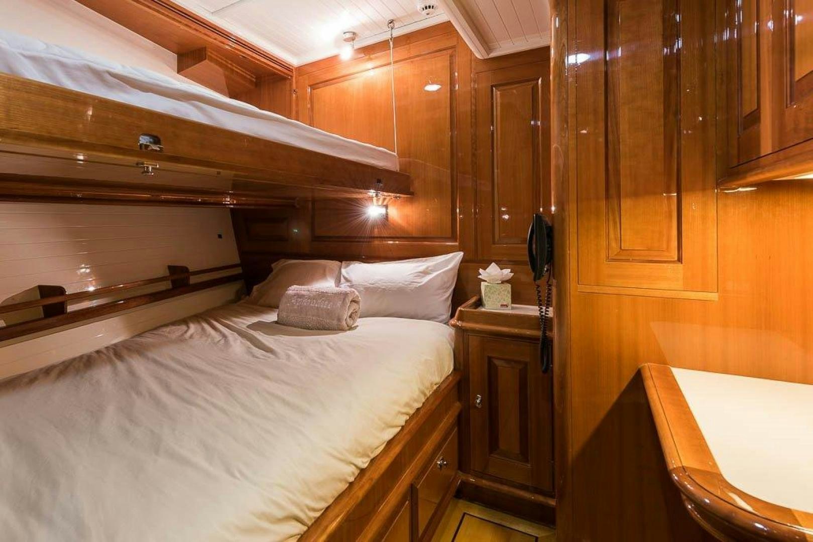 a room with a bed and a desk aboard DELUSHA Yacht for Sale