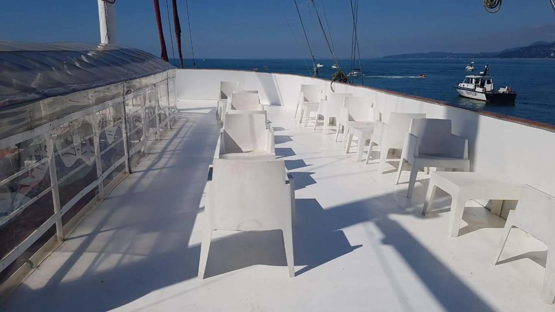a deck with chairs and a boat in the water aboard MY DREAM Yacht for Sale