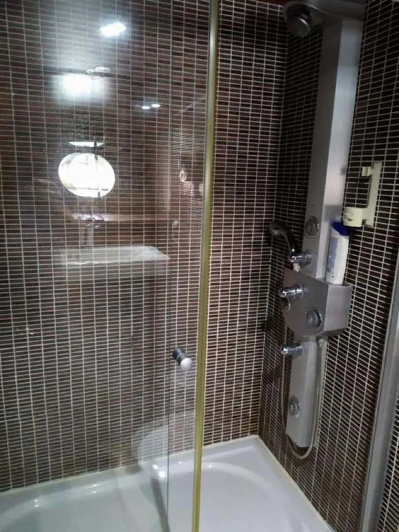 a bathroom with a shower and a tub aboard MY DREAM Yacht for Sale