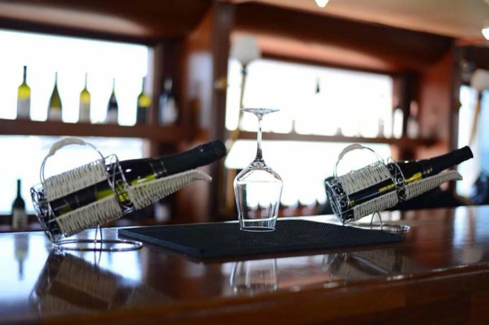 a glass bottle and a glass on a counter aboard MY DREAM Yacht for Sale