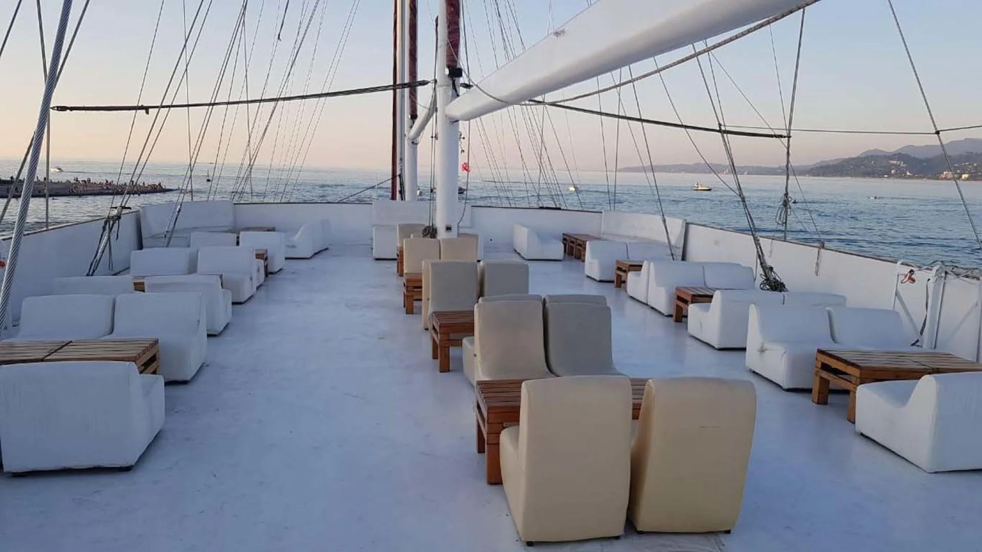 a boat deck with white couches aboard MY DREAM Yacht for Sale