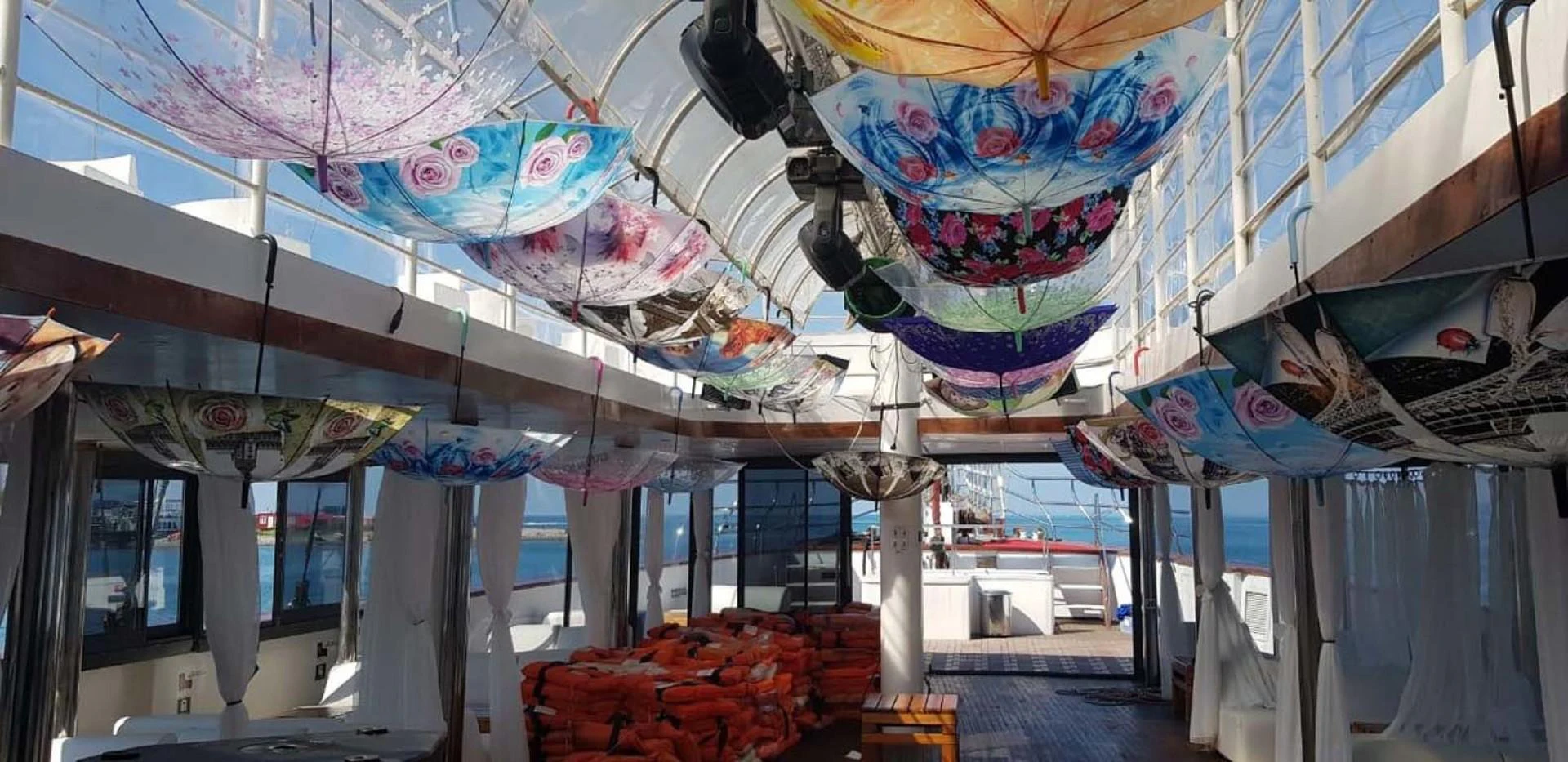 a room with a large display of colorful umbrellas aboard MY DREAM Yacht for Sale