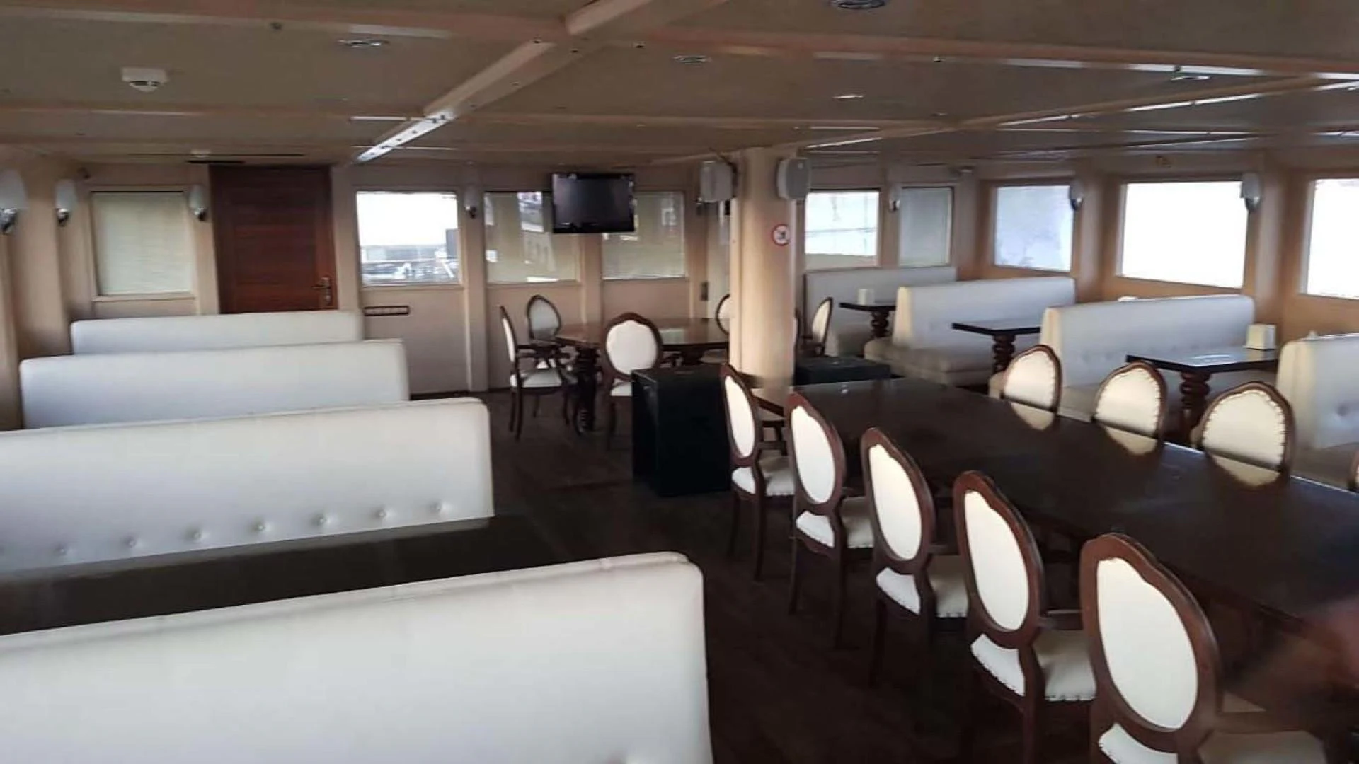 a room with tables and chairs aboard MY DREAM Yacht for Sale