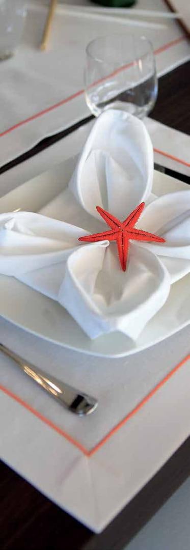 a glass with a red star on top of a white plate aboard DREW Yacht for Sale