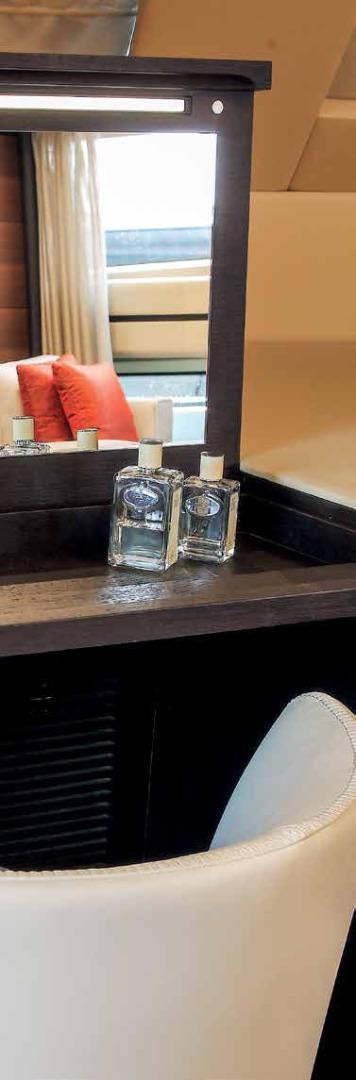 a glass bottle and a glass on a table aboard DREW Yacht for Sale