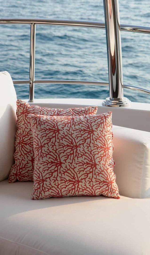 a red pillow on a couch aboard DREW Yacht for Sale