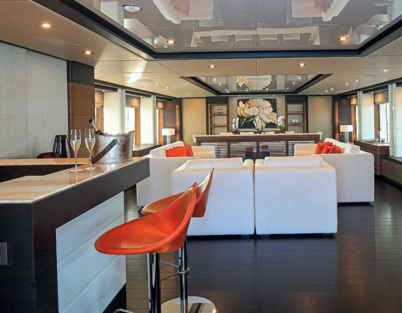 a room with a table and chairs aboard DREW Yacht for Sale