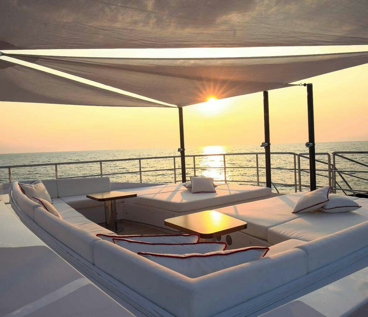 a lounge chair on a deck overlooking the ocean aboard DREW Yacht for Sale
