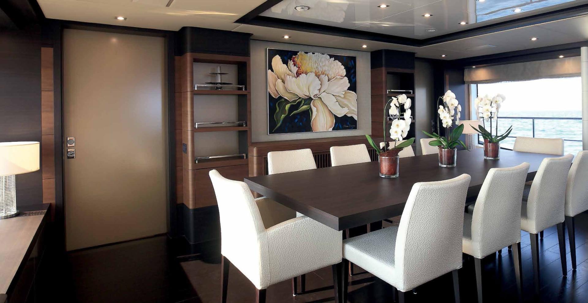 a room with a table and chairs aboard DREW Yacht for Sale