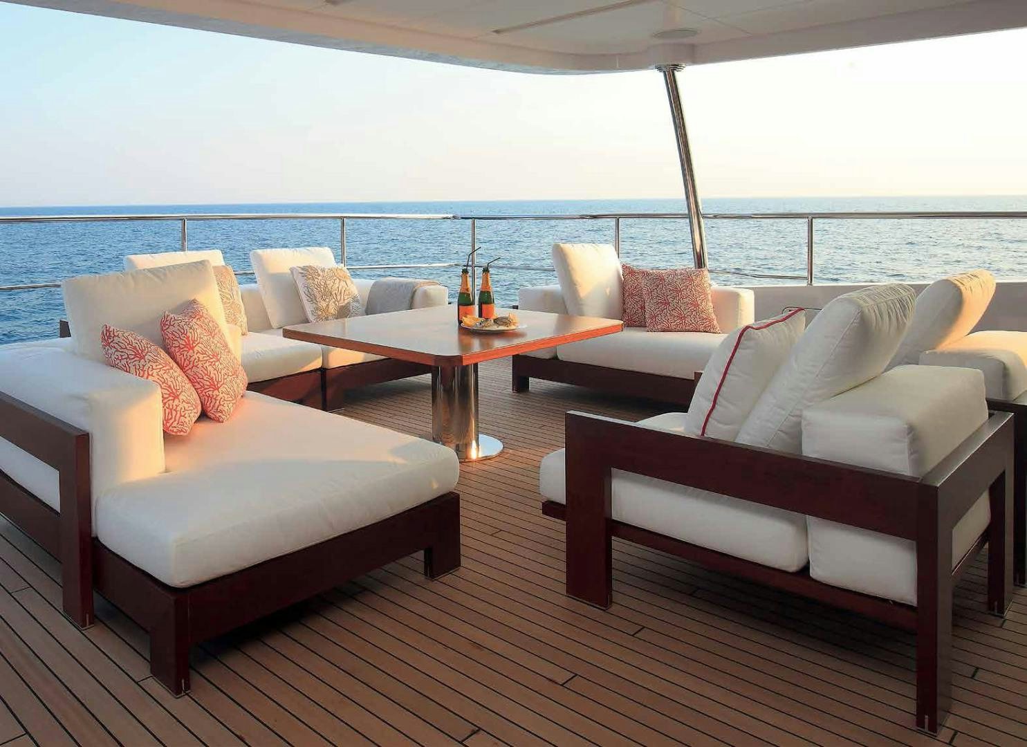 a room with a table and chairs aboard DREW Yacht for Sale